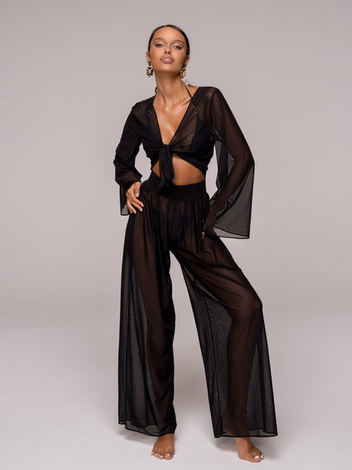 Introducing the unique Jannet&nbsp; set— the embodiment of elegance and lightness. This women's suit, made from Italian Carvico mesh, consists of wide, loose-fitting pants and a top with wide, flowing sleeves, making it perfect for creating a sophisticated look for beach parties and outings.