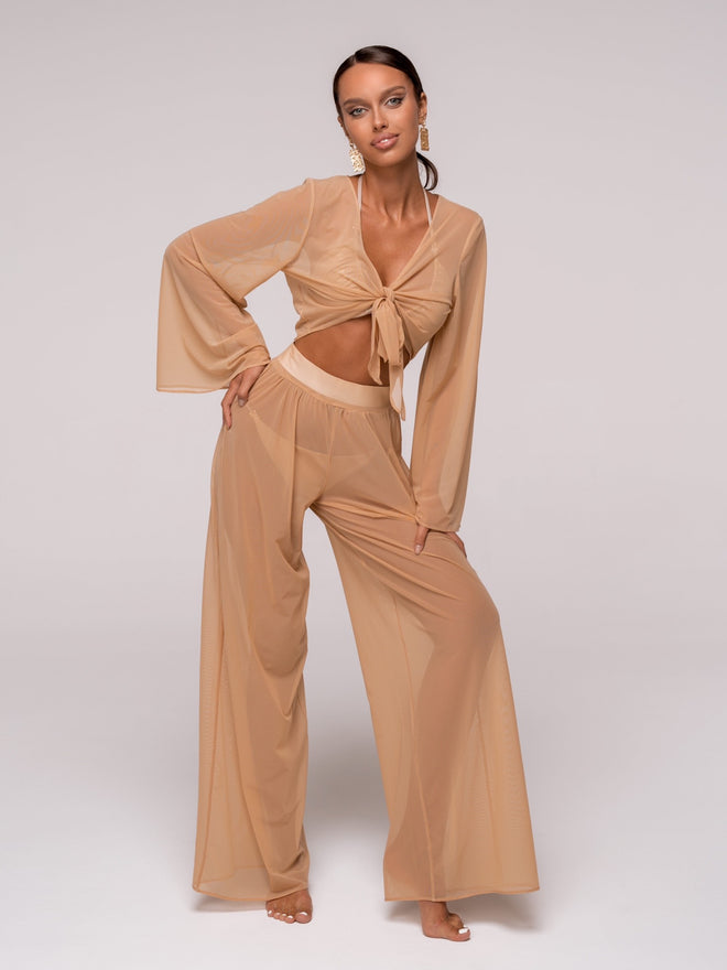 Introducing the unique Jannet set — the embodiment of elegance and lightness. This women's set, made from Italian Carvico mesh, consists of wide, loose-fitting pants and a top with wide, flowing sleeves, making it perfect for creating a sophisticated look for beach parties and outings.